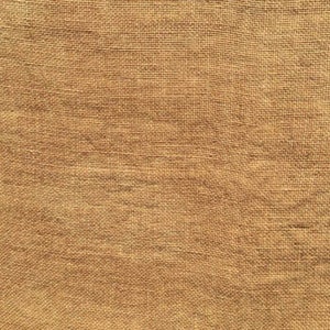 May include: Close-up of a tan burlap fabric. The fabric has a coarse, woven texture with visible threads. The colour is a warm, neutral tone, suitable for various craft and home decor projects. The weave is tight, creating a durable material.
