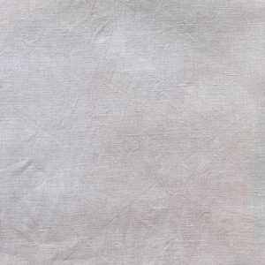 May include: A square of light gray linen fabric. The fabric has a textured appearance with visible woven threads and slight wrinkles. The color is a soft, neutral tone, suitable for various craft projects or home decor.