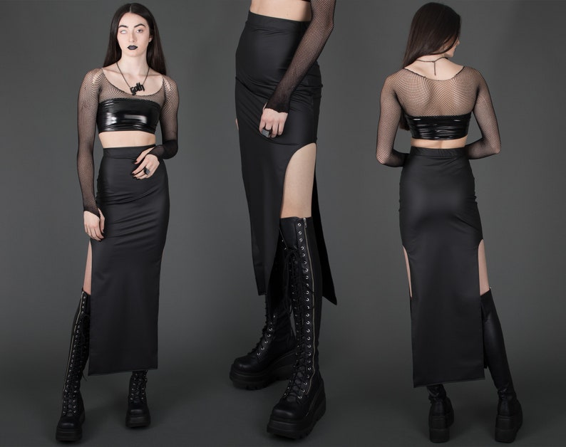 May include: A black maxi skirt with a high waist and a thigh-high slit on each side. The skirt is made of a smooth, stretchy fabric and has a sleek, modern design.