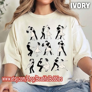 May include: Ivory-colored t-shirt featuring a repeating black graphic of couples dancing. The shirt has a crew neck and short sleeves. The text "IVORY" is printed at the top right. The Etsy shop URL is printed at the bottom.