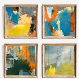 May include: Four framed abstract art prints. Each square print features a unique composition of brushstrokes in vibrant colors, including blue, yellow, orange, and green. The frames are a light wood color. The text "Frames not included" is at the bottom.