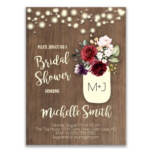 May include: A rustic wood background with a mason jar filled with burgundy and white flowers. The jar has the initials "M+J" written on it. The text "Please join us for a Bridal Shower honouring Michelle Smith" is written on the invitation. The date, time, location, RSVP information, and website are also included.
