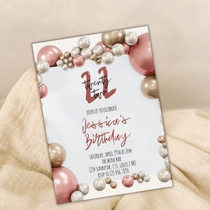 May include: A white invitation card with a pink and gold balloon border. The text on the card reads "Twenty Two" in a red script font, "Join us to celebrate Jessica's Birthday", "Saturday, April 29th at 7pm", "The Wine Bar", "1234 Sunny Dr. I St. Louis I MO", and "RSVP to 123.456.7890".