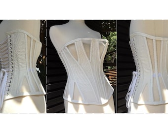 May include: A white corset with a mesh panel in the front and a lace-up back. The corset is made of a smooth, satin-like fabric.