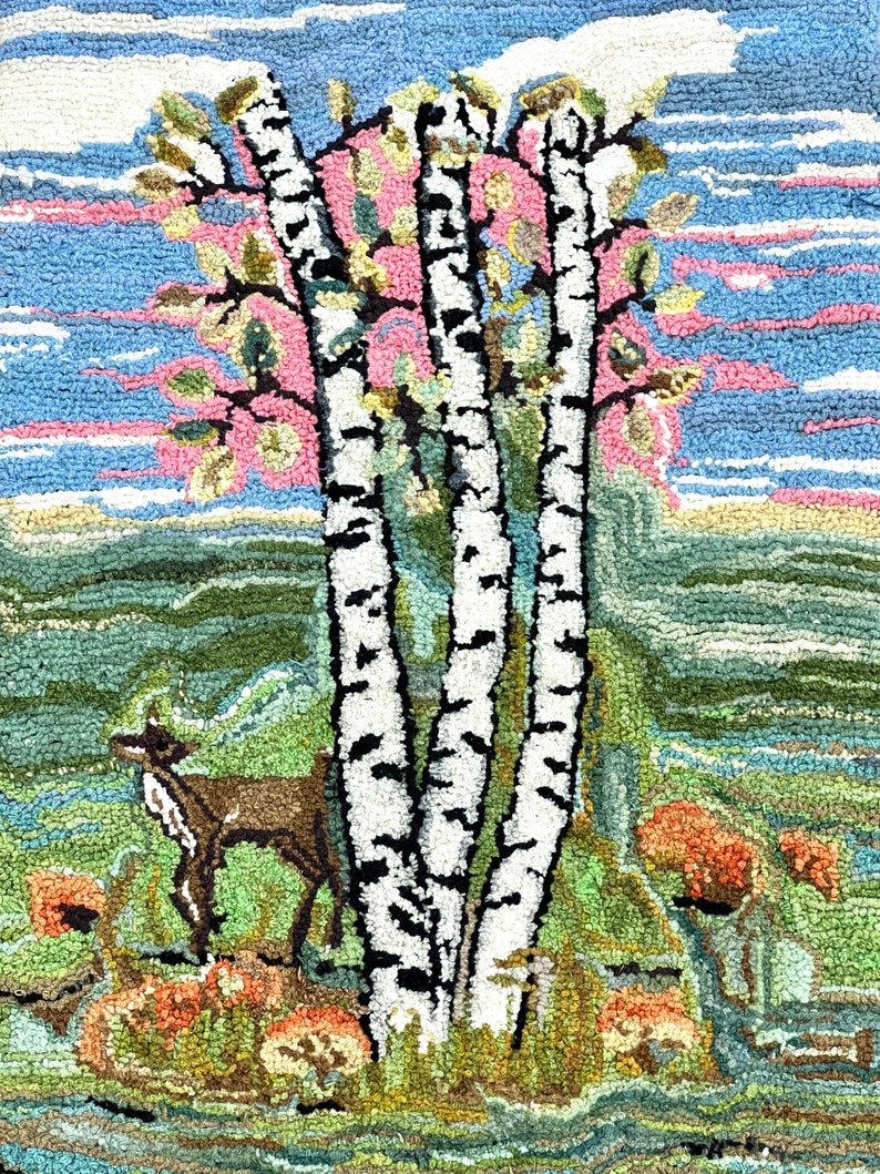 May include: A rug depicting a forest scene with three birch trees, a deer, and orange flowers. The sky is blue with pink clouds. The rug is made of yarn and has a textured surface.