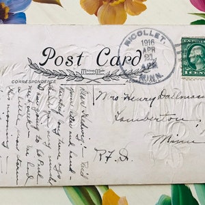 May include: Vintage postcard with a green 1-cent postage stamp and a postmark from Nicollet, Minnesota, dated April 21, 1916. The card features handwritten correspondence and an embossed floral design.
