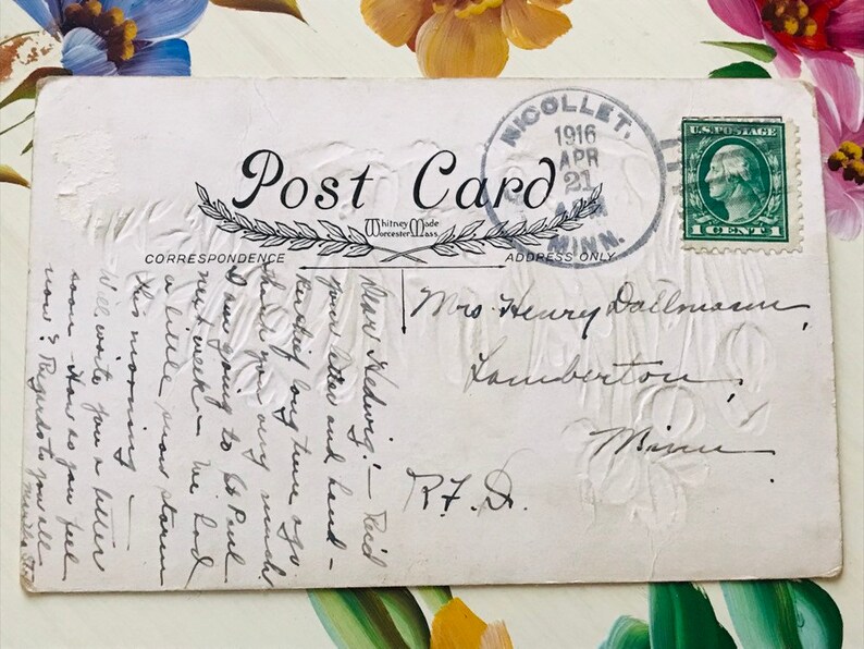 May include: Vintage postcard with a green 1-cent postage stamp and a postmark from Nicollet, Minnesota, dated April 21, 1916. The card features handwritten correspondence and an embossed floral design.