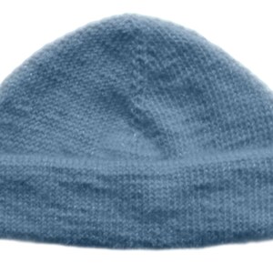 May include: A solid blue beanie hat with a folded brim. The hat is made of a knitted material and is a light shade of blue. The beanie is a classic style, suitable for cold weather.