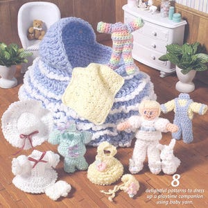 May include: A selection of crocheted baby items in pastel shades. The image shows a blue and white bassinet, clothing, and accessories. A doll and a small white bunny are also present. The text reads "8 delightful patterns to dress up a playtime companion using baby yarn."