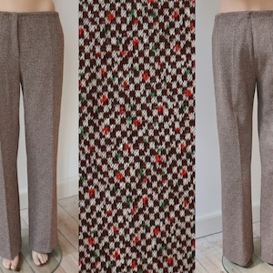 May include: Brown tweed pants with a straight leg. The pants are shown from the front and back. A close-up of the fabric shows a houndstooth pattern in brown, white, red, and green.
