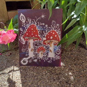 Acrylic painting of three Fly Agaric toadstools, magical mushroom, trippy toadstools