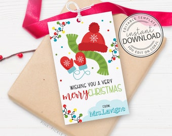 May include: A Christmas gift tag with a festive design. The tag features a red hat, mittens, and a green scarf, with string lights and the text "Wishing you a very Merry Christmas." The tag also includes the text "From Mrs. Lavigne."