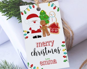 May include: A white Christmas gift tag with a festive design. The tag features illustrations of Santa Claus, a gingerbread man, a snowman, a Christmas tree, and a house. The words "merry christmas" and "Love, emma" are printed on the tag, along with decorative lights.