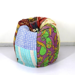 May include: A colorful patchwork bean bag chair with a variety of patterns, including floral, paisley, and geometric designs. The chair is made from recycled saris and is a unique and eco-friendly piece of furniture.