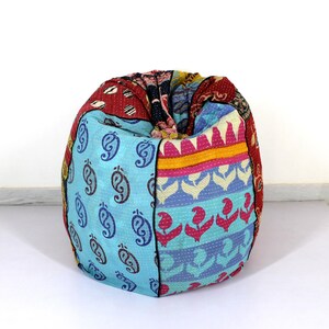 May include: A colourful patchwork bean bag chair with a variety of patterns, including paisley, floral, and geometric designs. The chair is made from a soft, quilted fabric and is perfect for lounging.