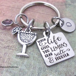 May include: Silver keychain with a margarita glass charm and a square tag that reads "When life gives you lemons grab salt & tequila".