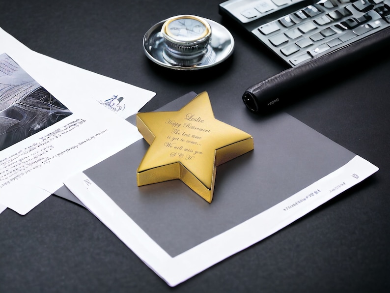 May include: A gold star-shaped award with the inscription "Happy Retirement.  The best time is yet to come... We will miss you!  S & H".