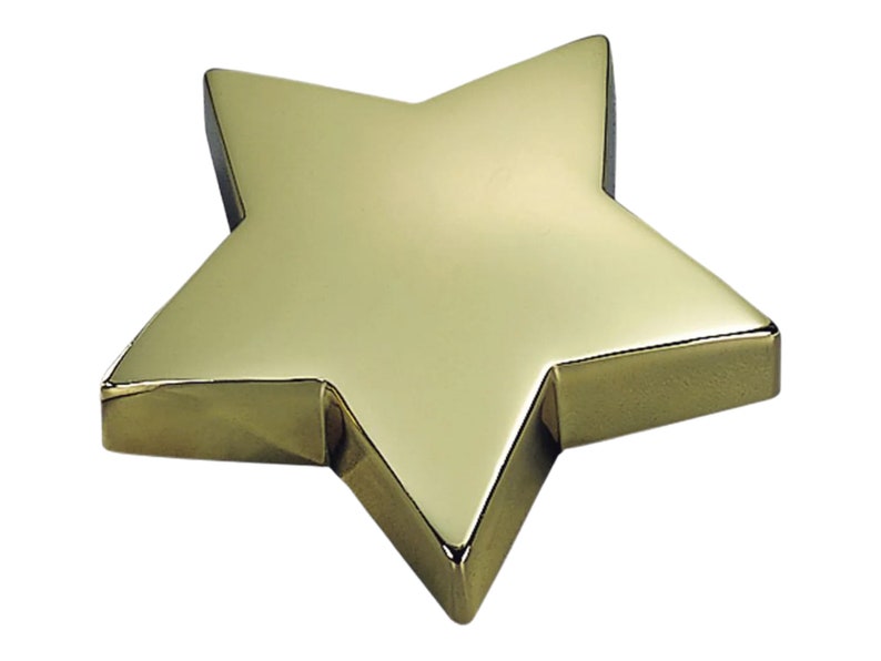 May include: A gold-colored, five-pointed star-shaped paperweight.