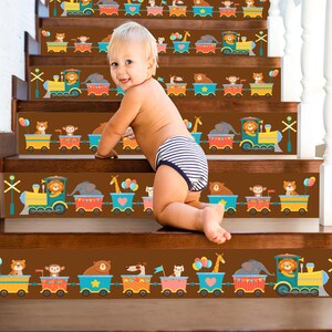 May include: A child is standing on a set of stairs with colorful train and animal themed decals. The decals are on each step of the stairs and feature a train with animals on it. The decals are a fun and whimsical way to decorate a child's room.