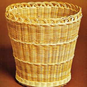 May include: A woven wicker basket with a scalloped top rim. The basket is light brown and has a natural, rustic look.