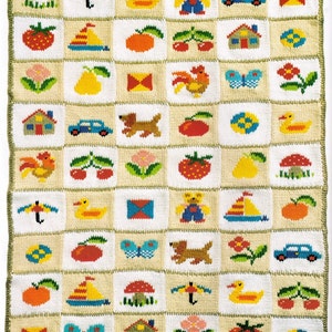 May include: A knitted baby blanket with a variety of colorful images, including a duck, a house, a butterfly, a car, a mushroom, a pear, a strawberry, a rooster, a dog, a tent, an umbrella, a sailboat, a bow, a cherry, a flower, and a teddy bear.
