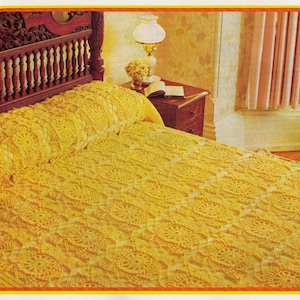 May include: A yellow crocheted bedspread with a delicate floral pattern. The bedspread is on a wooden bed frame with a carved headboard.