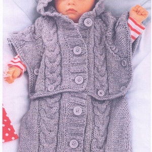 May include: A gray knitted baby sleeping bag with a hood and button closure. The sleeping bag has a cable knit pattern and is made of soft yarn.