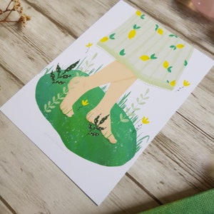 May include: A green and white illustration of a person's bare feet walking on a green patch of grass with yellow flowers. The person is wearing a white dress with a yellow lemon pattern. The text 'walk in the garden' is written in the bottom left corner of the image.
