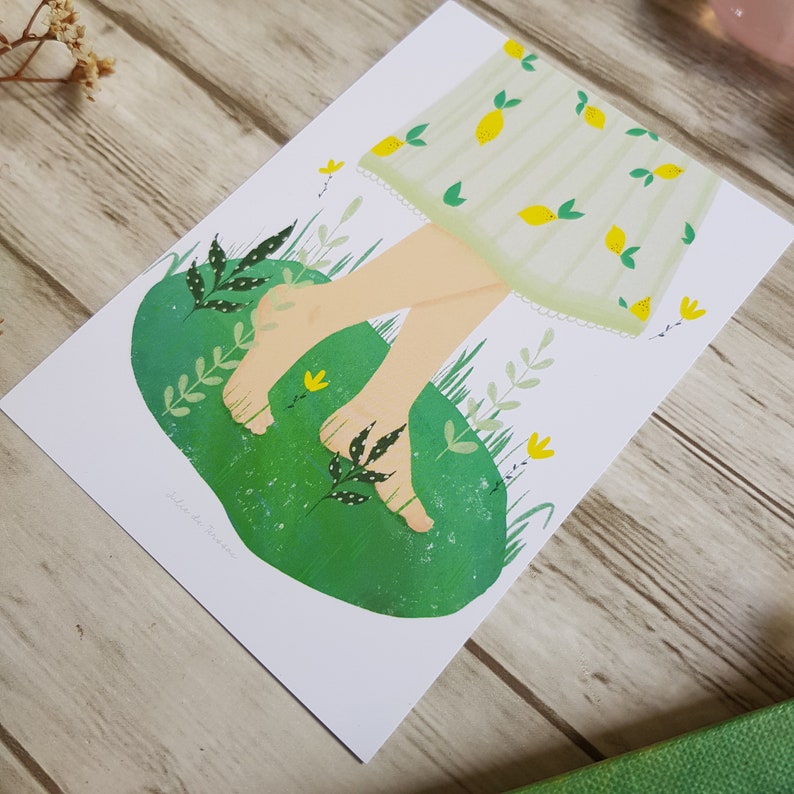 May include: A green and white illustration of a person's bare feet walking on a green patch of grass with yellow flowers. The person is wearing a white dress with a yellow lemon pattern. The text 'walk in the garden' is written in the bottom left corner of the image.