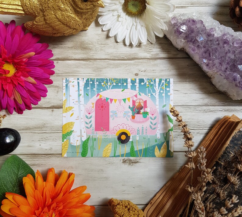 May include: A pink camper van with a white door and windows. The camper van is decorated with flowers, flags, and a sign that says 'Let's Go!' The camper van is surrounded by green trees and bushes. The image is on a white background.
