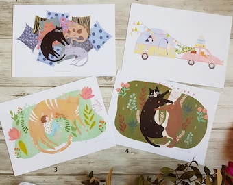 May include: Four illustrated cards featuring cats in various scenes. The first card shows two cats sleeping on a pile of colourful pillows. The second card shows a cat driving a camper van with another cat riding in the back. The third card shows a cat sleeping with a small person. The fourth card shows two cats hugging in a green field.