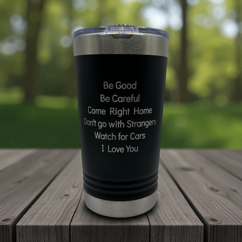 Puede incluir: Vaso t&eacute;rmico negro con borde y tapa plateados. El vaso tiene el siguiente texto en blanco: "Be Good, Be Careful, Come Right Home, Don't go with Strangers, Watch for Cars, I Love You."