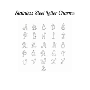 May include: Stainless steel letter charms in a cursive font. The letters A through Z are displayed in alphabetical order.