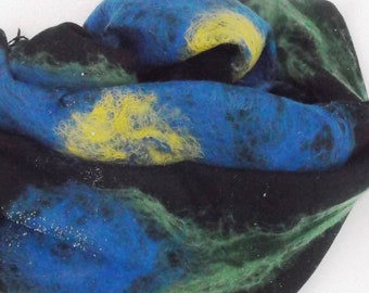 May include: A black wool scarf with blue, yellow, and green abstract designs. The scarf is folded and appears soft and textured.
