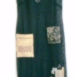 May include: A dark green, sheer, sleeveless dress with a beaded neckline and embroidered patches. The dress has a loose fit and a flowing silhouette.