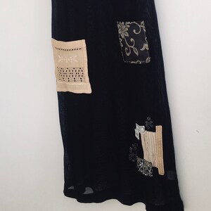 May include: A black mesh dress with various beige and brown fabric patches, including a floral design and a lace pattern.