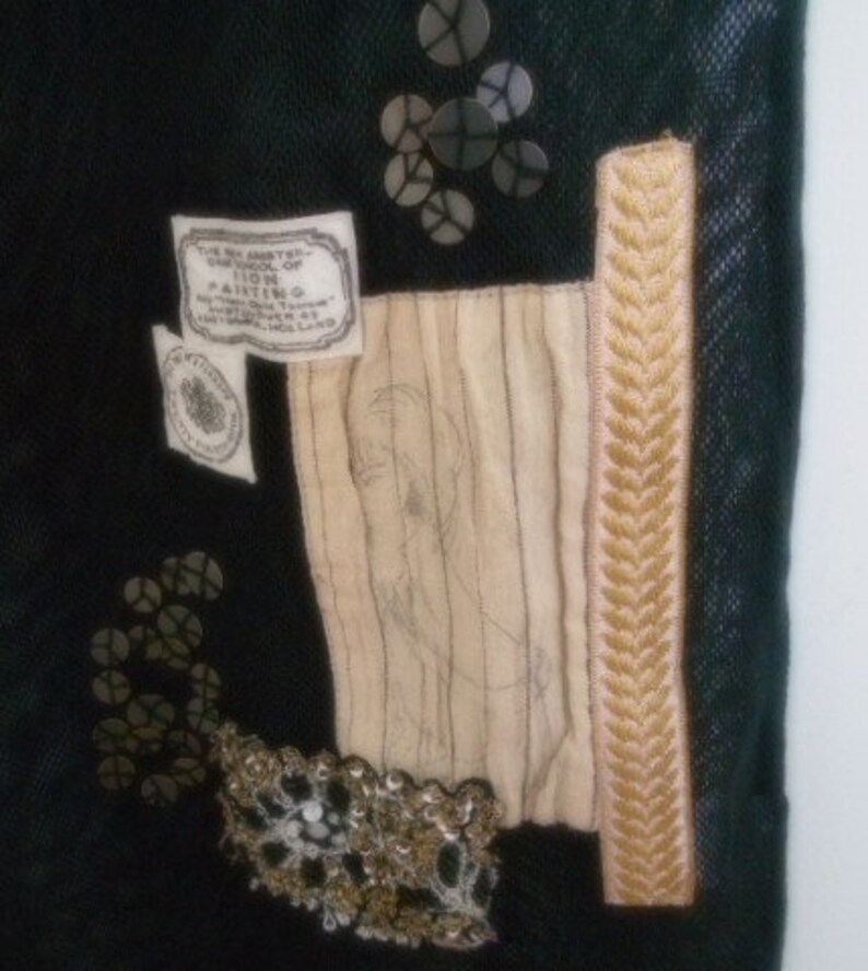 May include: A black fabric bag with a beige fabric panel and a gold trim. The bag has a label that reads "The Art Gallery, 1100, Painting, Amsterdam, Holland".
