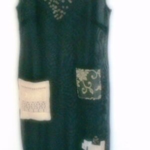May include: A dark green, sheer, sleeveless dress with a beaded neckline and patchwork details. The dress has a loose fit and a flowing silhouette.