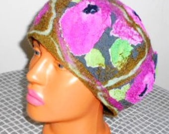 May include: A brown felt hat with a floral design. The flowers are pink, green, and blue. The hat has a square pattern around the brim.