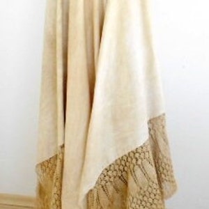 May include: A long, white skirt with a lace trim. The skirt is made of a lightweight fabric and has a flowing silhouette.