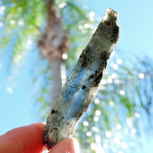 Raw blue kyanite mineral specimen with mica inclusions, highly reflective and natural.