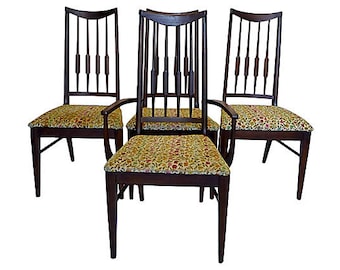 May include: Set of four mid-century modern dining chairs with dark wood frames and floral patterned upholstery.