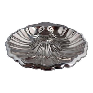 May include: A silver, shell-shaped dish with a fluted design. The dish is made of metal and has a smooth, polished finish.