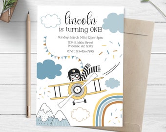 May include: A printable invitation for a first birthday party with a blue, yellow, and white airplane theme. The invitation features a cartoon illustration of a child wearing a pilot hat and goggles flying a yellow airplane. The text on the invitation reads "lincoln is turning ONE!" and includes the date, time, address, and RSVP information.
