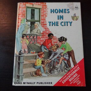 May include: A vintage children's book cover titled "Homes in the City" with an illustration of children playing on a stoop in front of a brick building. The book is part of the "Start-Right Elf Book" series and is educationally sound.