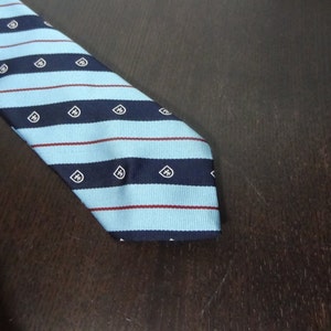 Clearance - Men&#39;s Polyester Light Blue Necktie with Navy Blue and Red/Maroon Stripes and White and Navy Blue Crests
