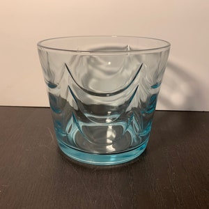 May include: A clear blue glass tumbler with a wavy design.