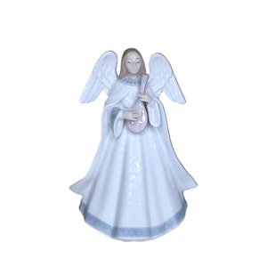 May include: A ceramic angel figurine with outstretched wings, wearing a flowing white gown with a light blue trim. The angel holds a pink and white stringed instrument. The figurine has a serene expression and is set against a white background.