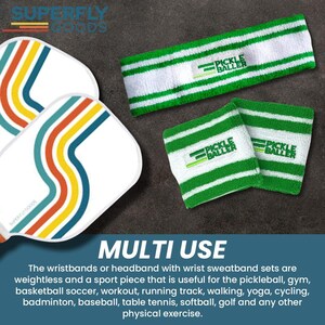 May include: White pickleball paddles with colorful stripes and a green and white striped headband and wristbands. The wristbands and headband have the text "PICKLE BALLER". The image also includes the text "MULTI USE".