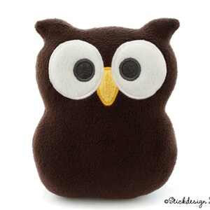 May include: A brown plush owl with large white eyes and a yellow beak. The owl is sitting on a white background.
